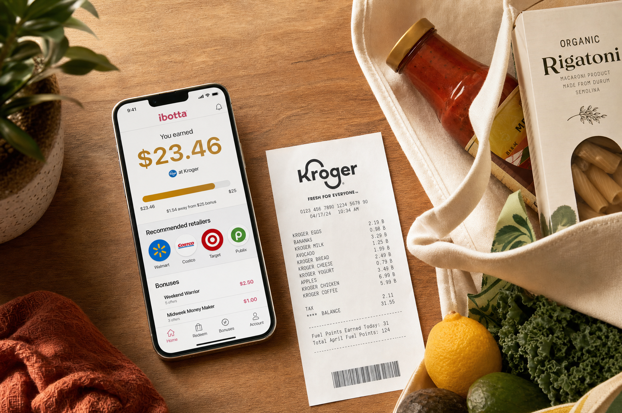 Smartphone showing rebate app next to grocery bags